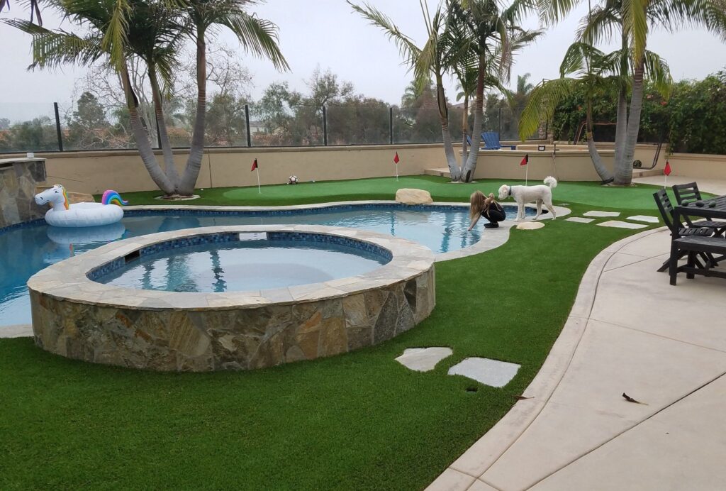 Private Backyard Putting Green in artificial grass around pool