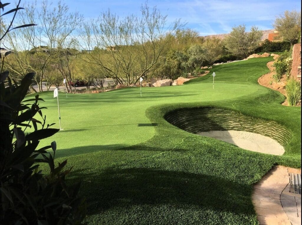 Private Backyard Putting Green in artificial grass with stacked sod bunler
