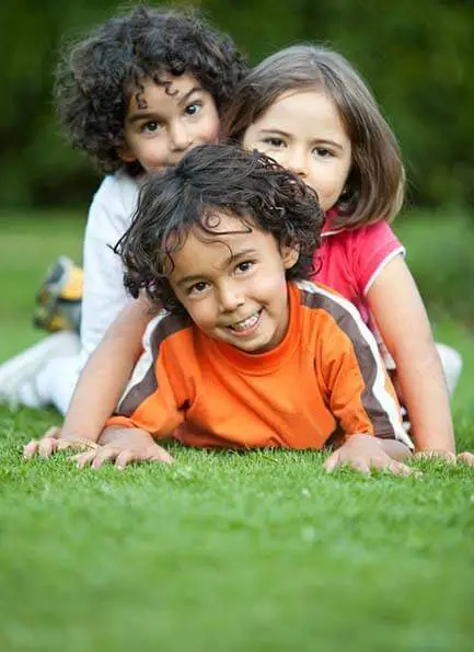 kids playing on artificial grass landscaping